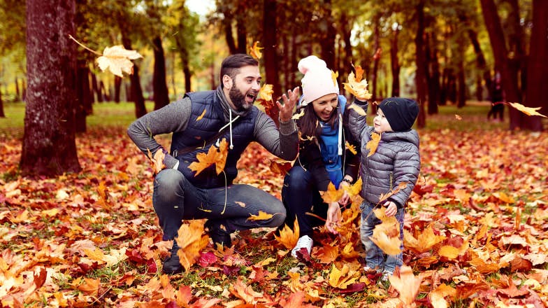 Family outdoors with tree leaves